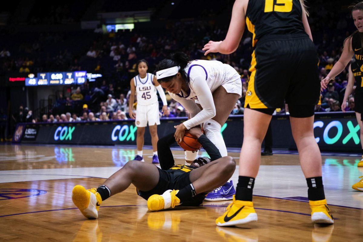 LSU women’s basketball fifth year senior forward and guard Awa Trasi (32) and Missouri women’s basketball junior guard Aijha Blackwell (33) fight for the ball Thursday, Jan. 13, 2022, during LSU’s 87-85 overtime win against Missouri in the Pete Maravich Assembly Center on North Stadium Drive in Baton Rouge, La.