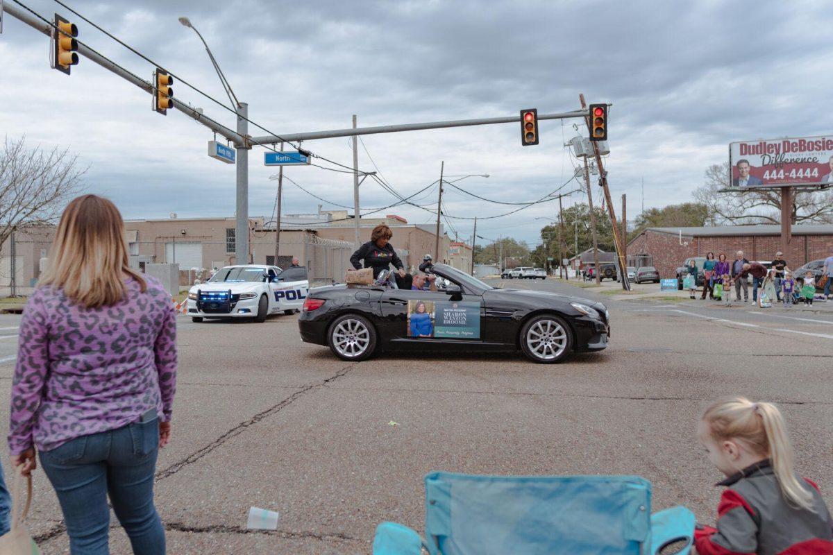 Baton Rouge Mayor-President Sharon Weston Broome throws beads from a car on Sunday, Feb. 20, 2022, as part of the Mid City Gras parade on North Boulevard in Baton Rouge, La.