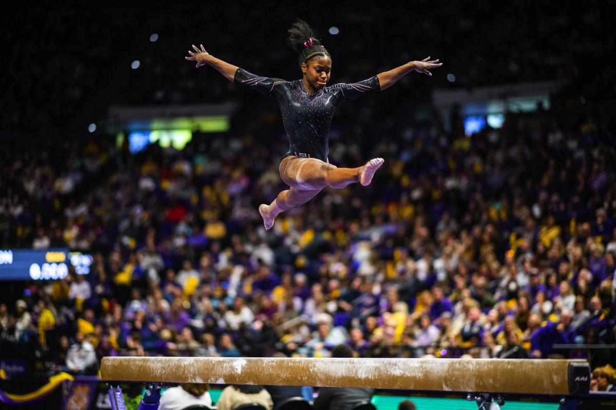 <p>LSU gymnastics junior all-around Kiya Johnson performs her balance beam routine Saturday, Feb. 5, 2022 during LSU's 197.975-197.750 win over Auburn in the Pete Maravich Assembly Center on N. Stadium Drive in Baton Rouge, La.</p>