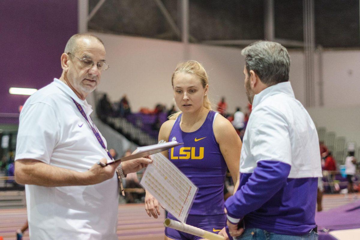 LSU track and field fifth-year senior Lisa Gunnarsson discusses her last jump with her coaches on Friday, Feb. 4, 2022, during the Bayou Bengal indoor track meet at the Carl Maddox Field House on Nicholson Drive in Baton Rouge, La.