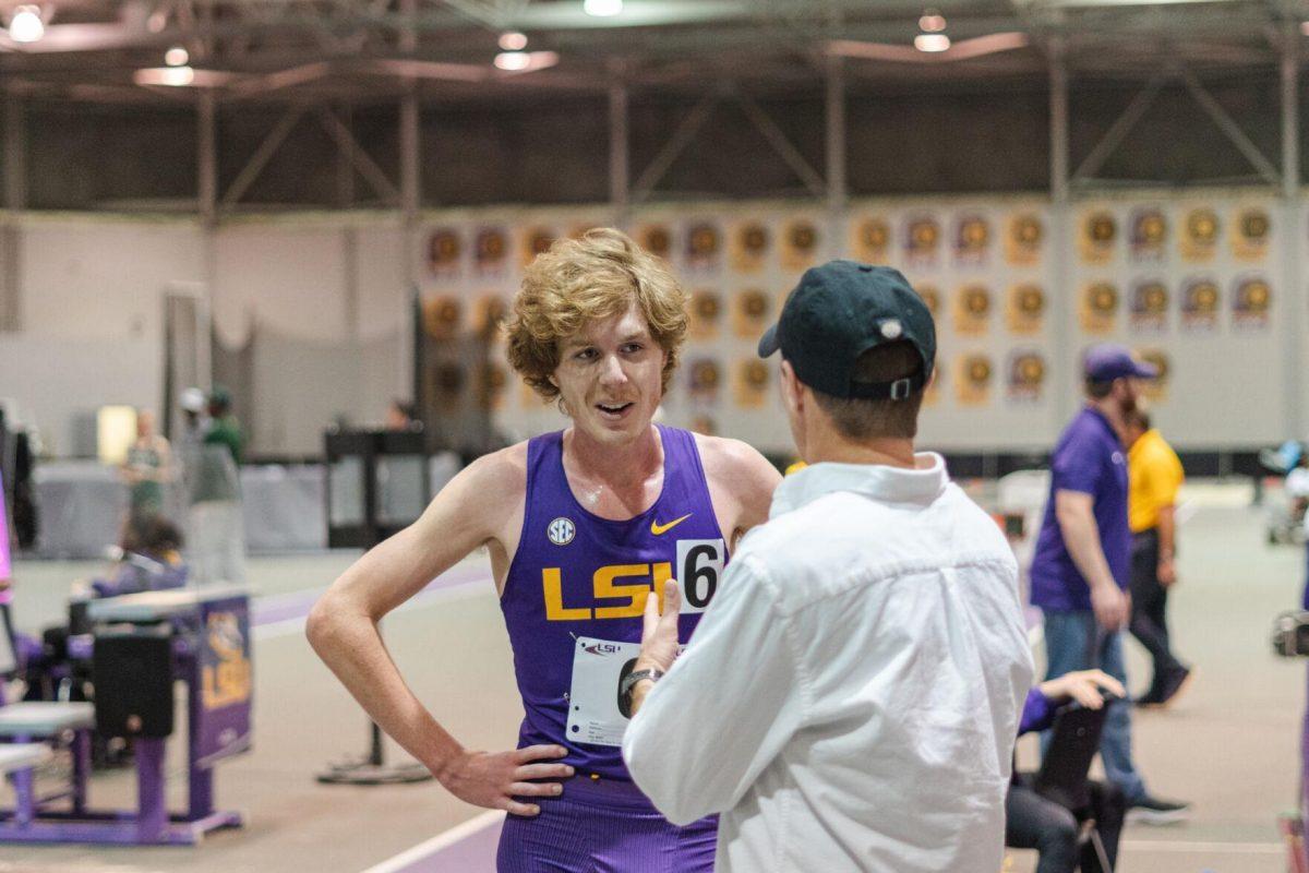 LSU track and field distance sophomore Cade Martin speaks with his coach on Friday, Feb. 18, 2022, during the LSU Twilight track and field meet in the Carl Maddox Field House on Nicholson Drive in Baton Rouge, La.