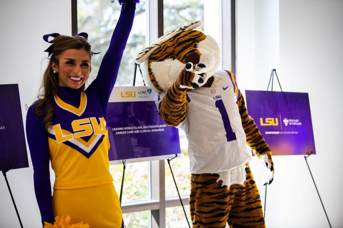 Mike the Tiger and an LSU cheerleader welcome guests to the Our Lady of the Lake and LCMC Health game-changing investment press conference Friday, Feb. 11, 2022, at the LSU Foundation Center for Philanthropy in Baton Rouge, La.