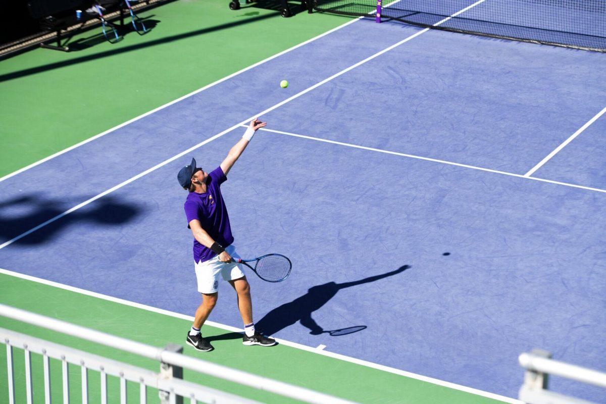 LSU men's tennis junior Boris Kozlov throws the ball up Sunday, Feb. 13, 2021 during LSU's 6-1 win over Purdue at the LSU Tennis Complex on Gourrier Avenue in Baton Rouge, La.