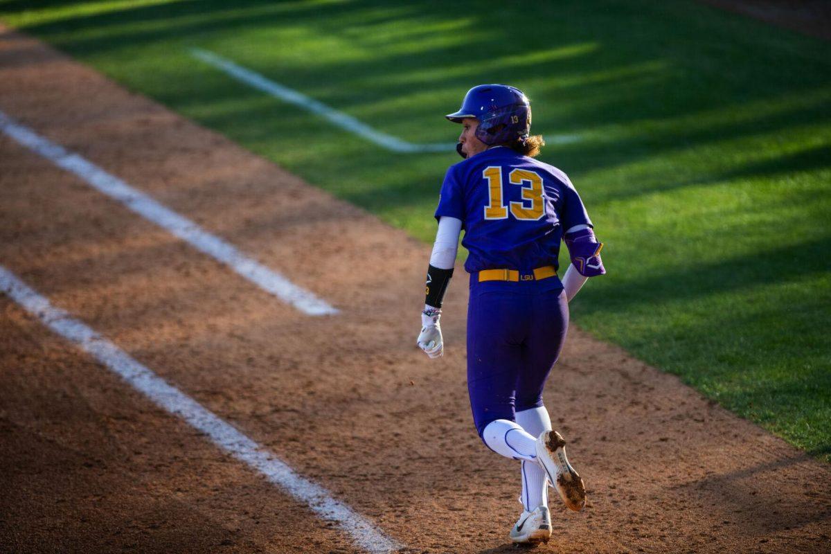 LSU softball sophomore infielder Danieca Coffey (13) runs to first Friday, Feb. 11, 2022, during the Tigers' 3-0 win against South Alabama at Tiger Park in Baton Rouge, La.