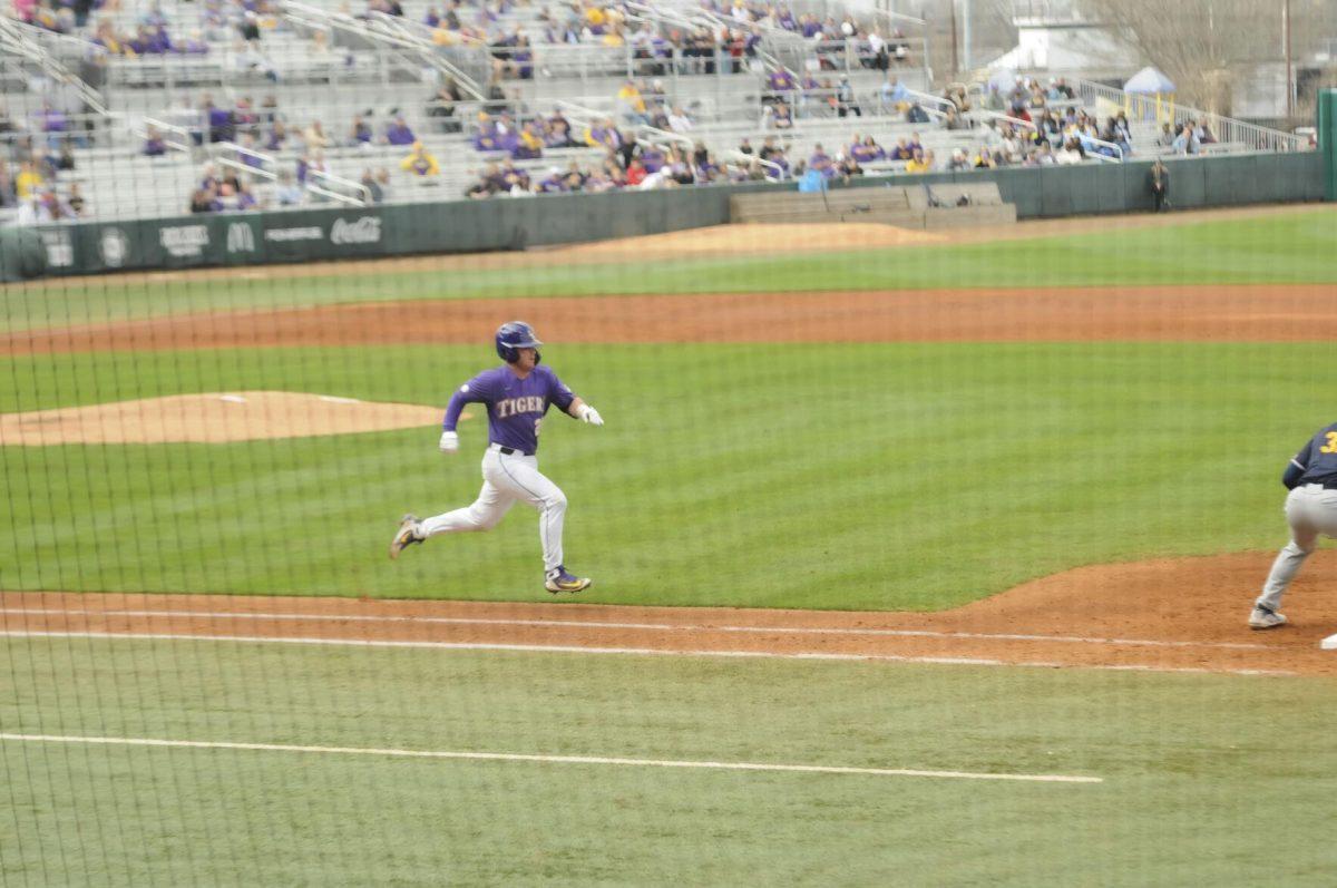 LSU sophomore catcher Alex Milazzo (20) runs to first base after the swing Saturday, Feb. 26, 2022, during the Tigers' 9-2 win against Southern University at Alex Box Stadium in Baton Rouge, La.