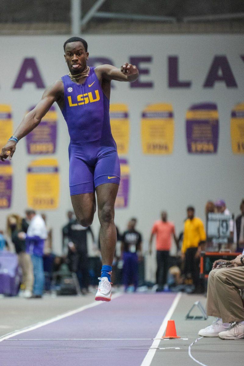 LSU track and field sophomore Sean Dixon-Bodie leaps from the board on Friday, Feb. 4, 2022, while biting his tongue during the Bayou Bengal indoor track meet at the Carl Maddox Field House on Nicholson Drive in Baton Rouge, La.
