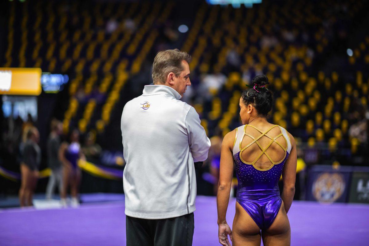 LSU gymnastics head coach Jay Clark and sophomore all-around Haleigh Bryant talk during warmups Saturday, Feb. 5, 2022 before LSU's 197.975-197.750 win over Auburn in the Pete Maravich Assembly Center on N. Stadium Drive in Baton Rouge, La.