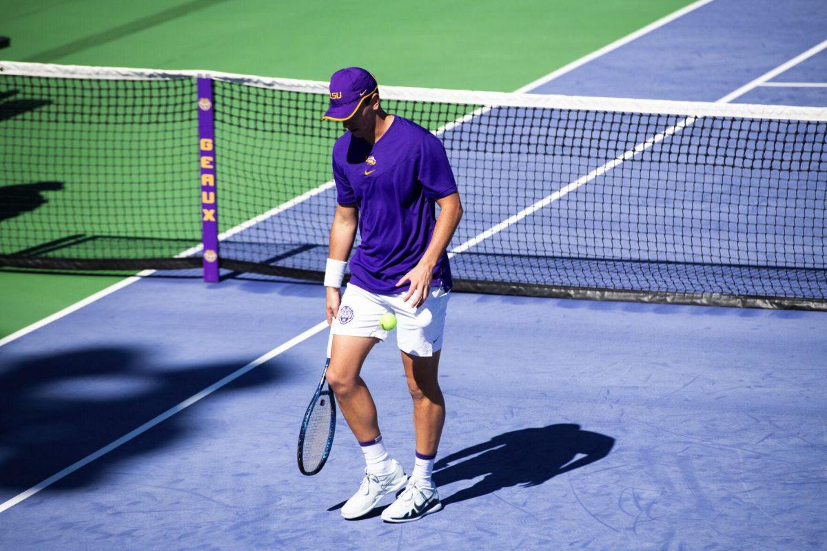 LSU men's tennis graduate student Gabriel Diaz Freire drops a tennis ball Sunday, Feb. 13, 2021 during LSU's 6-1 win over Purdue at the LSU Tennis Complex on Gourrier Avenue in Baton Rouge, La.