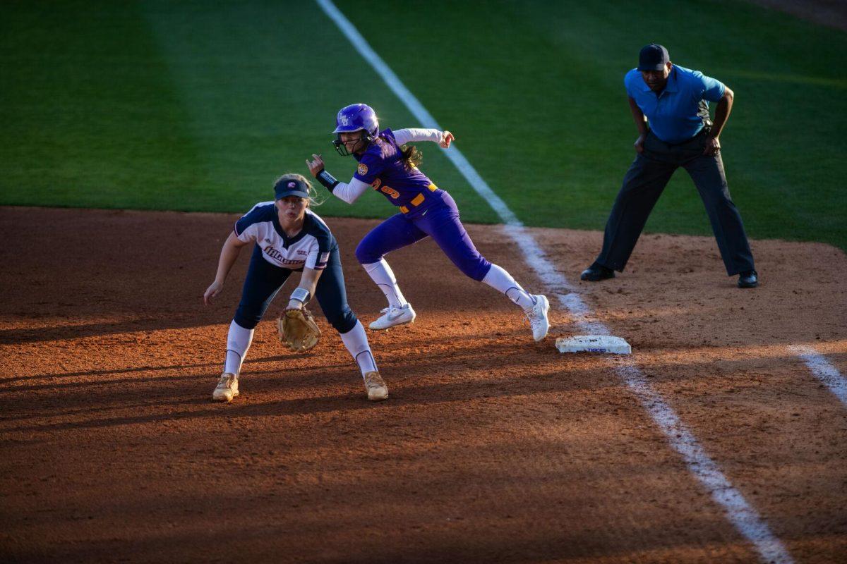 LSU softball freshman outfielder Madilyn Giglio (9) takes a lead off of first base Friday, Feb. 11, 2022, during the Tigers' 3-0 win against South Alabama at Tiger Park in Baton Rouge, La.