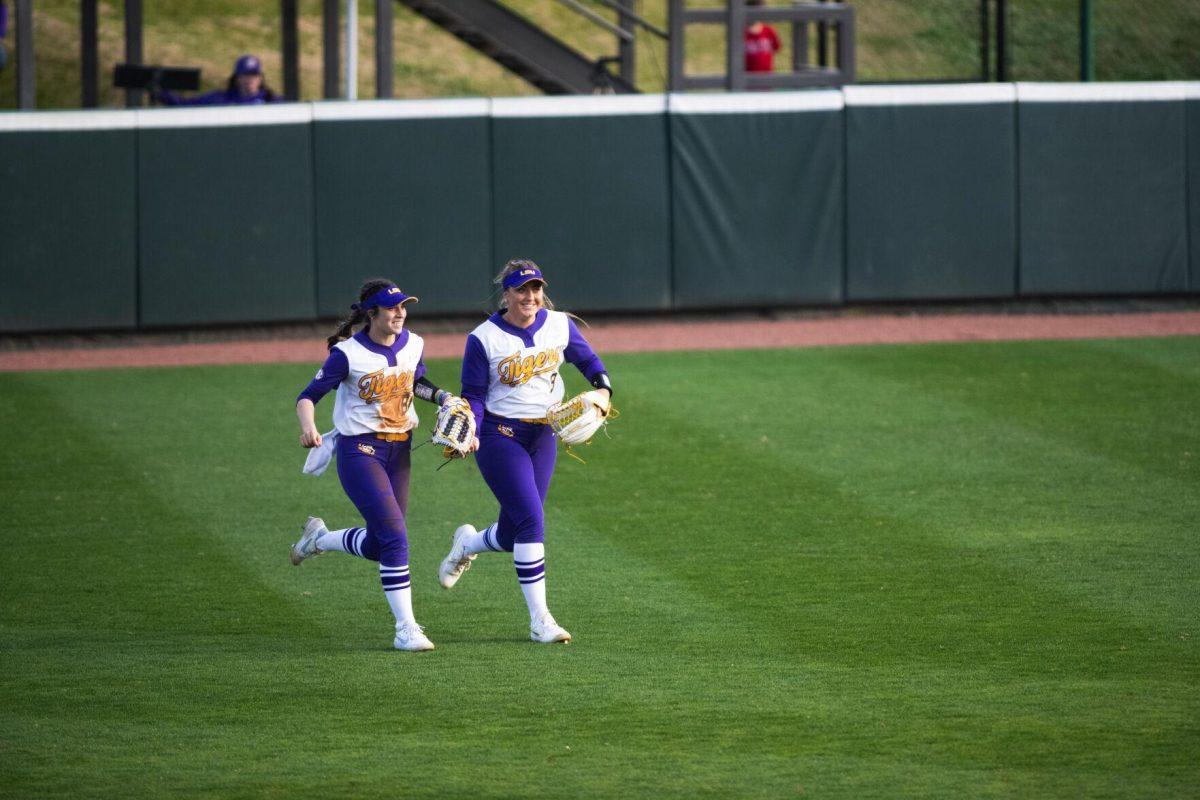 LSU softball sophomore outfielder Ciara Briggs (88) and junior outfielder Savannah Stewart (8) run off the field together at the end of the inning Saturday, Feb. 12, 2022, during LSU’s 8-1 win against South Alabama at Tiger Park on Skip Bertman Drive in Baton Rouge, La.