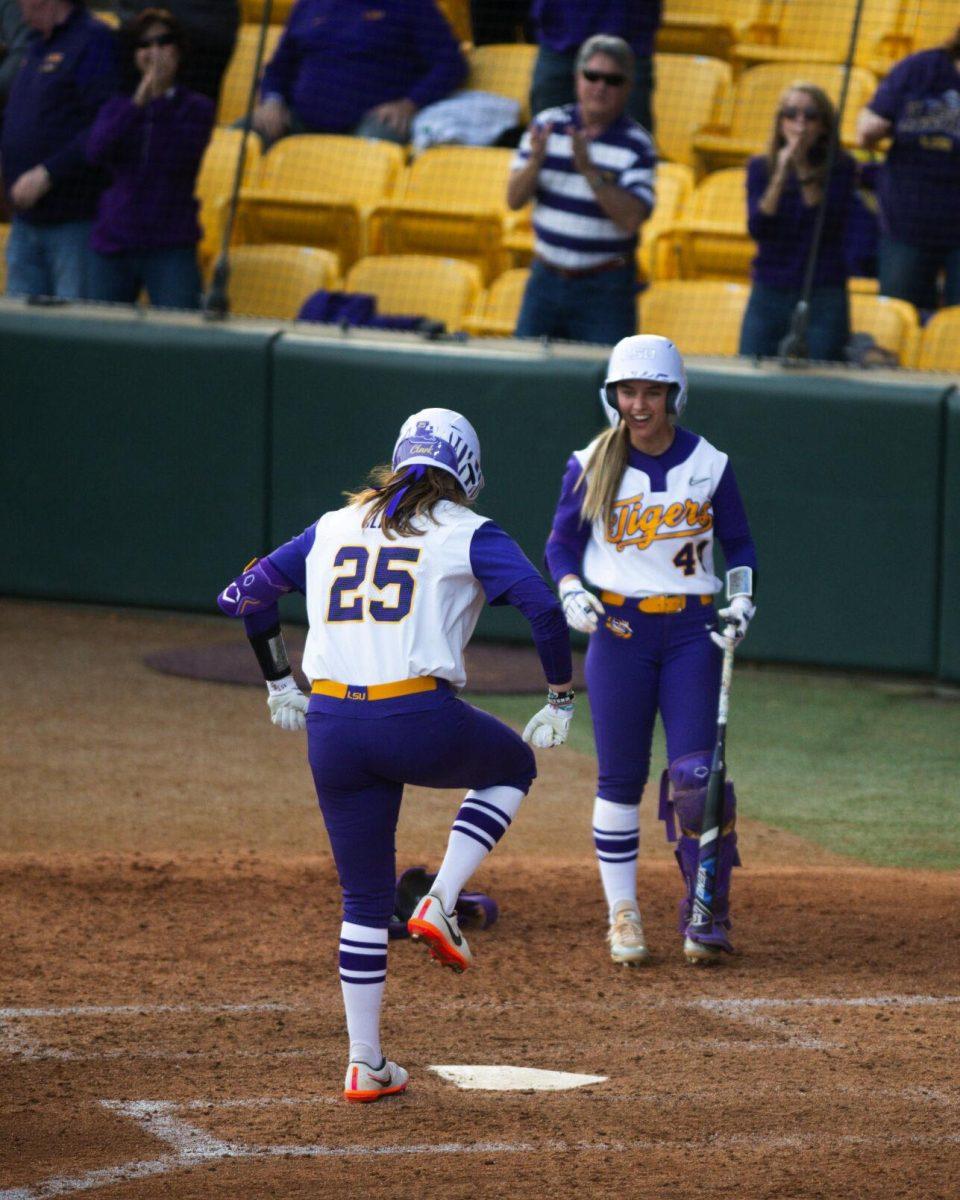 LSU softball junior infielder Georgia Clark (25) raises her foot to stomp on home plate after hitting a homerun Saturday, Feb. 12, 2022, during LSU’s 8-1 win against South Alabama at Tiger Park on Skip Bertman Drive in Baton Rouge, La.