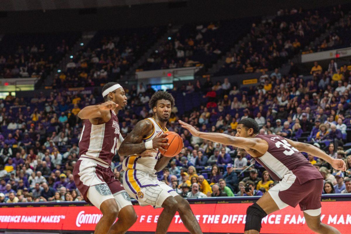 LSU men&#8217;s basketball sophomore forward Tari Eason (13) tries to evade defenders on Saturday, Feb. 12, 2022, during LSU&#8217;s 69-65 win over Mississippi State in the Pete Maravich Assembly Center on North Stadium Drive in Baton Rouge, La.