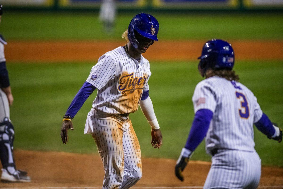 LSU baseball sophomore first baseman Tre Morgan III (18) high fives sophomore outfielder Dylan Crews (3) Friday, Feb. 18, 2022 before LSU's 13-1 win against Maine at Alex Box Stadium on Gourrier Avenue in Baton Rouge, La.