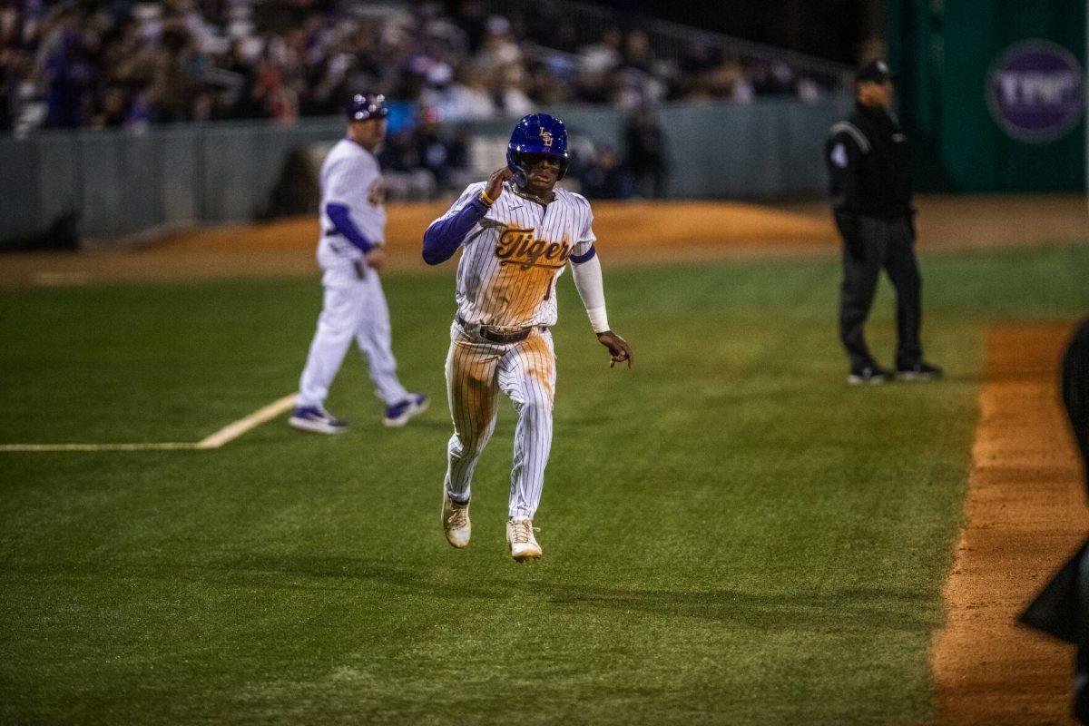 LSU baseball sophomore first baseman Tre Morgan III (18) runs to home plate Friday, Feb. 18, 2022 before LSU's 13-1 win against Maine at Alex Box Stadium on Gourrier Avenue in Baton Rouge, La.