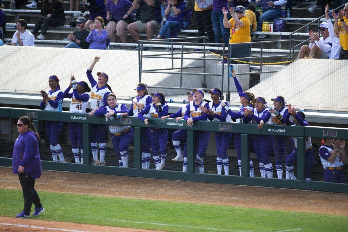 The LSU softball players cheer from the dugout after fifth year senior pitcher/utility Shelbi Sunseri (27) hits a homerun Saturday, Feb. 12, 2022, during LSU’s 8-1 win against South Alabama at Tiger Park on Skip Bertman Drive in Baton Rouge, La.