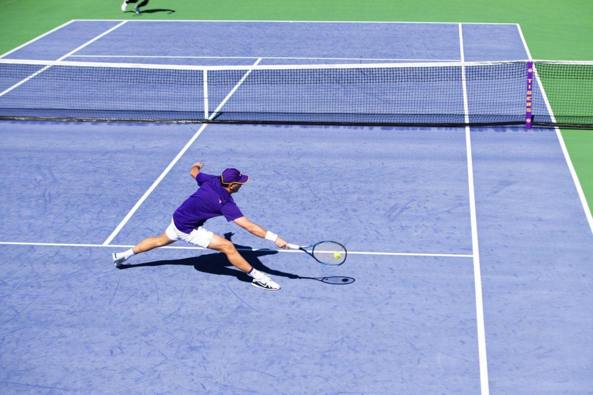 LSU men's tennis graduate student Gabriel Diaz Freire stretches out to hit the ball Sunday, Feb. 13, 2021 during LSU's 6-1 win over Purdue at the LSU Tennis Complex on Gourrier Avenue in Baton Rouge, La.