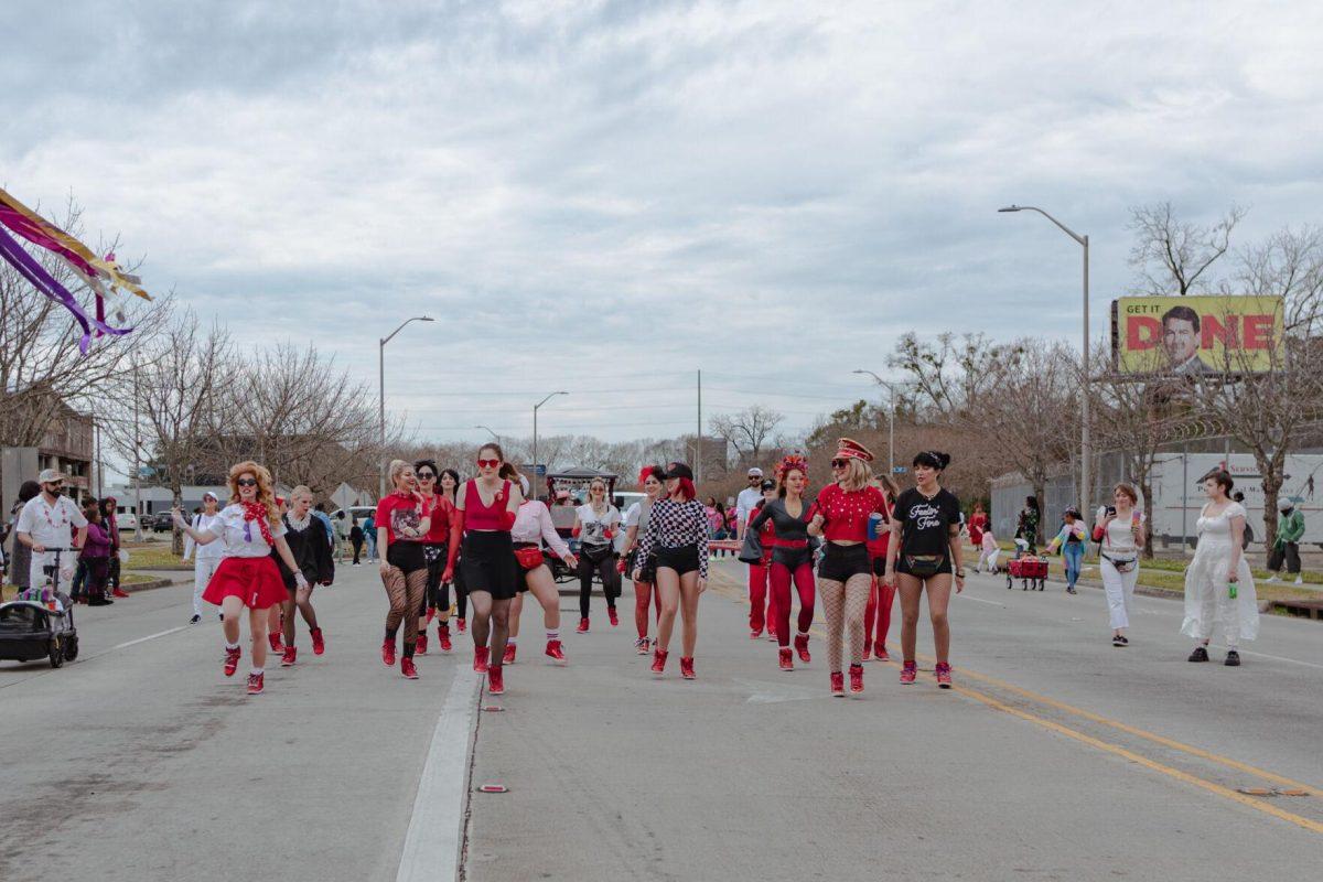 A group of dancers perform on Sunday, Feb. 20, 2022, as part of the Mid City Gras parade on North Boulevard in Baton Rouge, La.