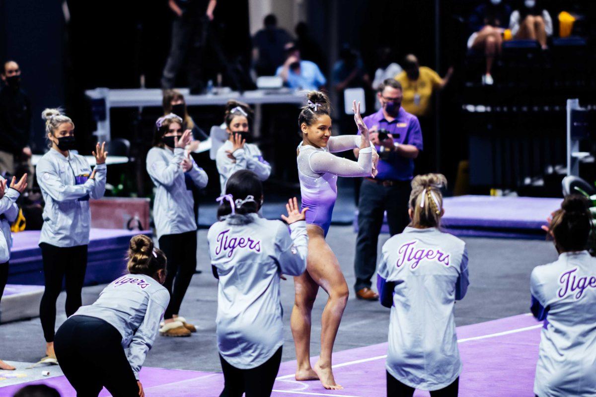 LSU gymnastics freshman all-around Haleigh Bryant performs her floor routine while her teammates cheer her on Friday, March 3, 2021 during LSU's 197.875-196.175 win over Missouri in the Pete Maravich Assembly Center on N. Stadium Drive in Baton Rouge, La.