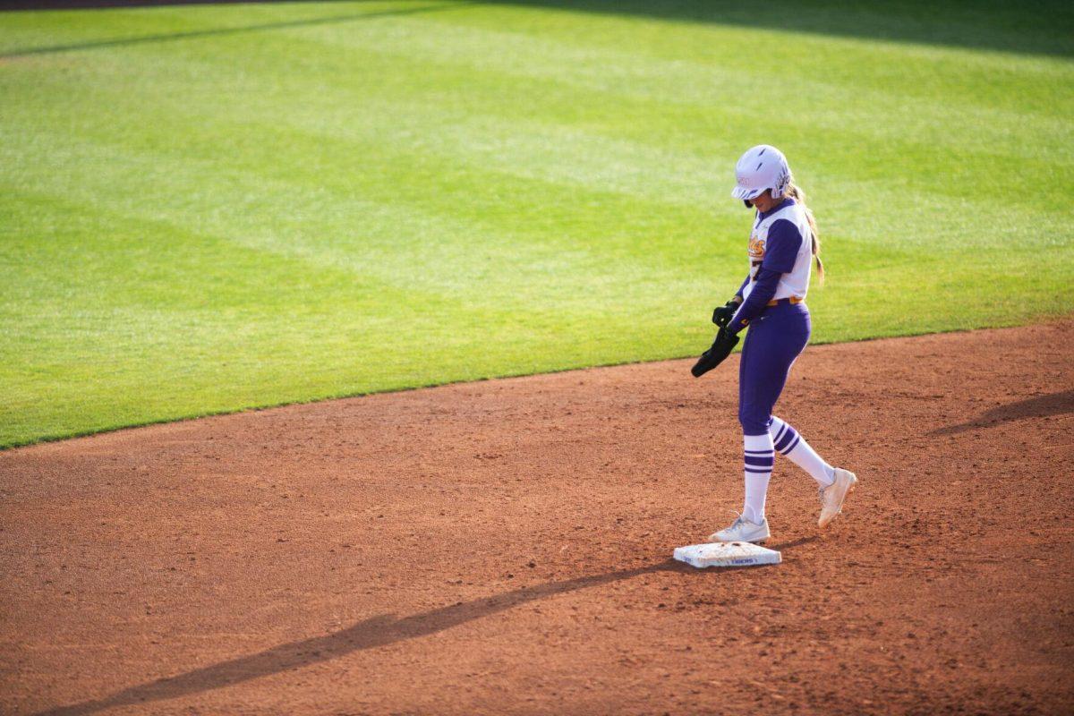 LSU softball sophomore infielder Taylor Pleasants (17) takes off her batting sleeve Saturday, Feb. 12, 2022, during LSU’s 8-1 win against South Alabama at Tiger Park on Skip Bertman Drive in Baton Rouge, La.