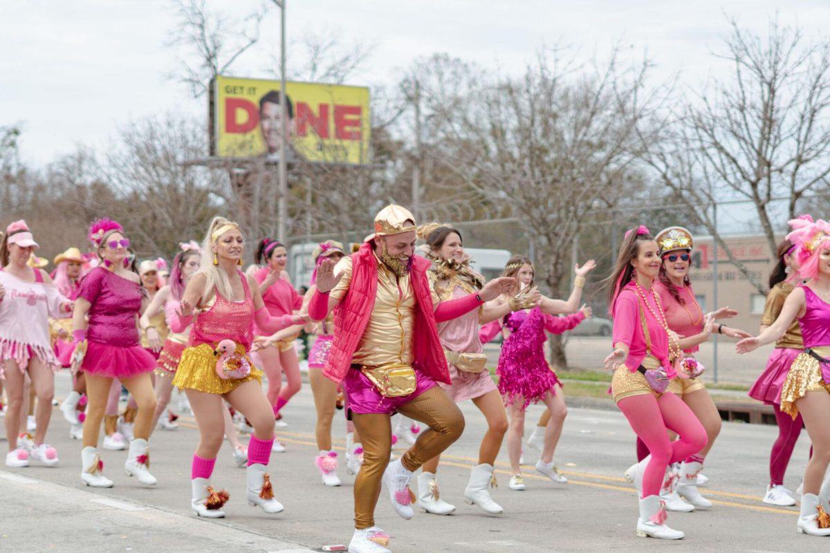 A group of dancers perform on Sunday, Feb. 20, 2022, as part of the Mid City Gras parade on North Boulevard in Baton Rouge, La.