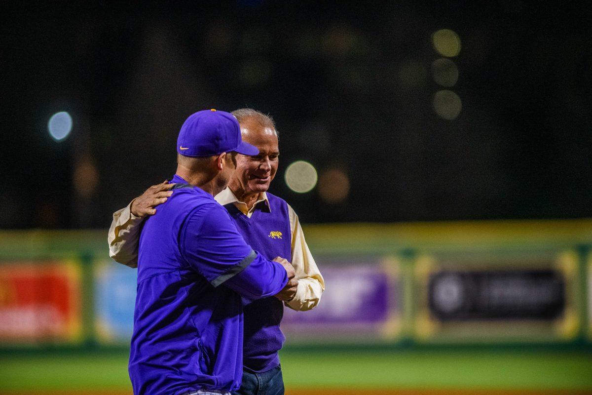 Former head coach Paul Mainieri and LSU head coach Jay Johnson walk back to the dugout Friday, Feb. 18, 2022 before LSU's 13-1 win against Maine at Alex Box Stadium on Gourrier Avenue in Baton Rouge, La.