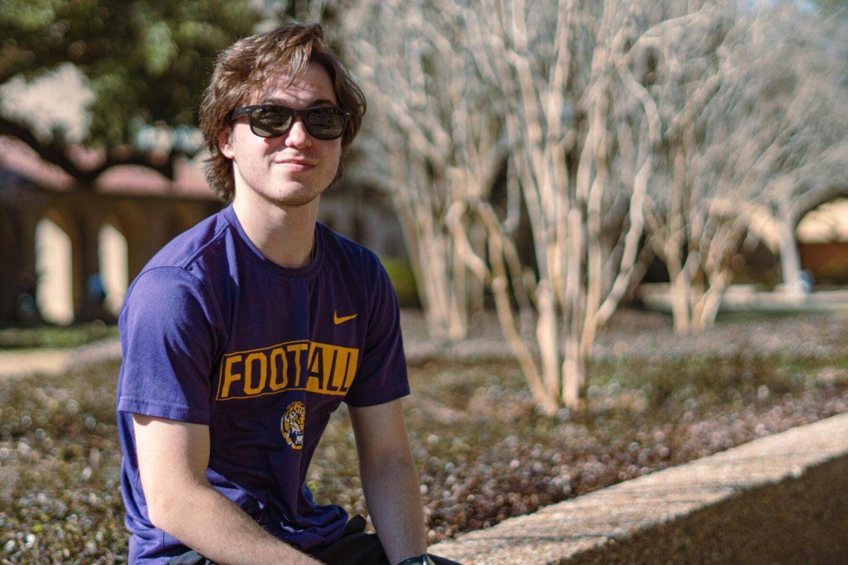 LSU sophomore kinesiology major Chandler Power wears an LSU football shirt on Thursday, Feb. 10, 2022, while sitting in the LSU Quad in Baton Rouge, La.