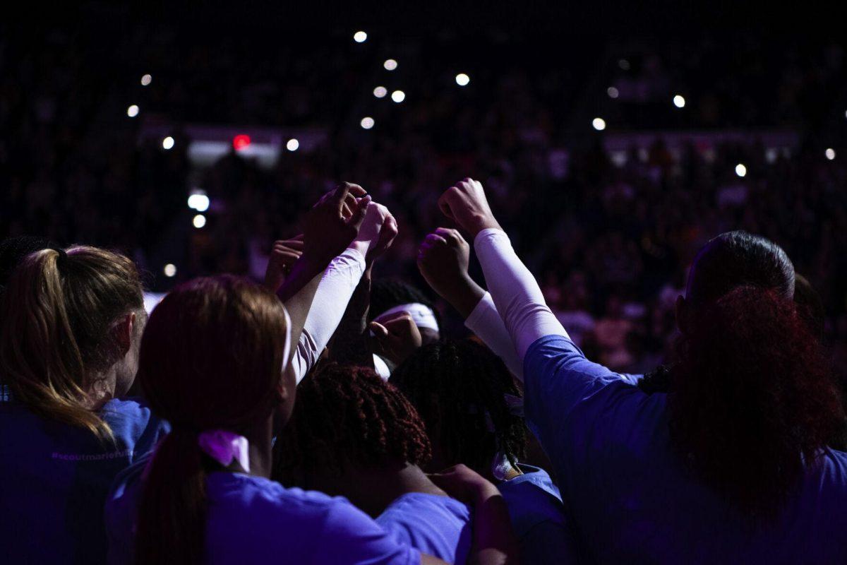 Members of the LSU women's basketball team raise their fists Sunday, Feb. 20, 2022, before LSU’s 66-61 win against Florida in the Pete Maravich Assembly Center on North Stadium Drive in Baton Rouge, La.