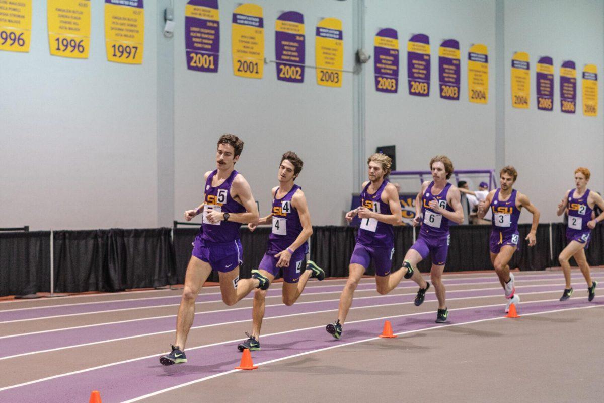 LSU track and field distance runners round the bend on Friday, Feb. 18, 2022, in the 3000-meter run during the LSU Twilight track and field meet in the Carl Maddox Field House on Nicholson Drive in Baton Rouge, La.