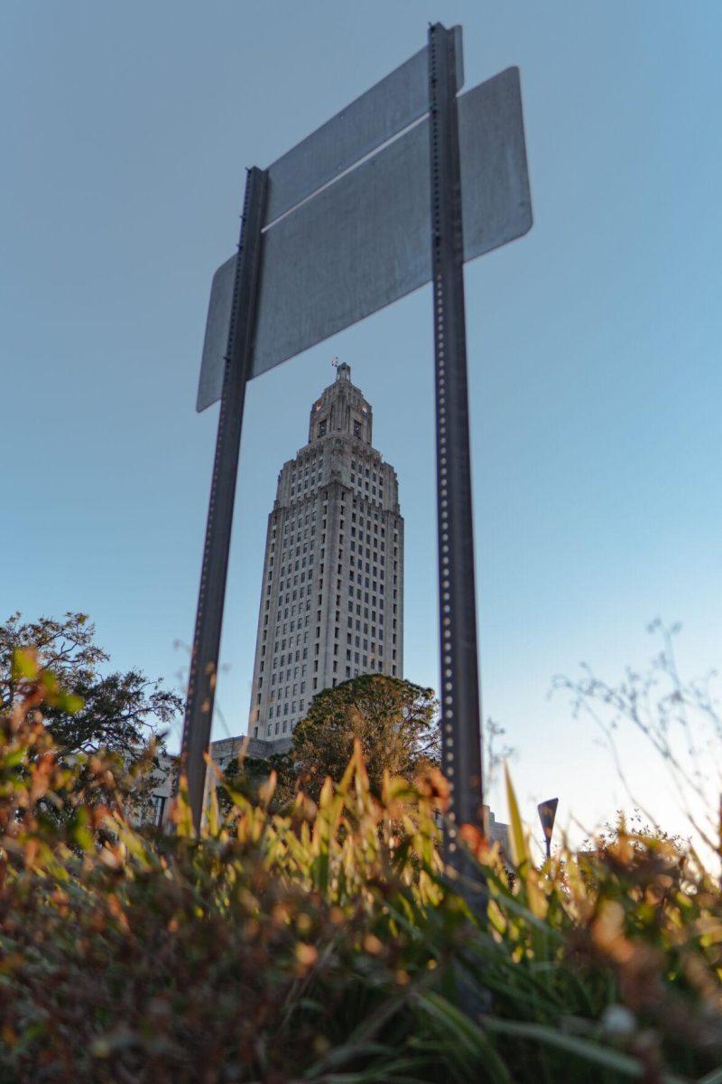 The State Capitol appears to fit between the posts of a street sign on Sunday, Feb. 6, 2022, at 900 North Third Street in Baton Rouge, La.