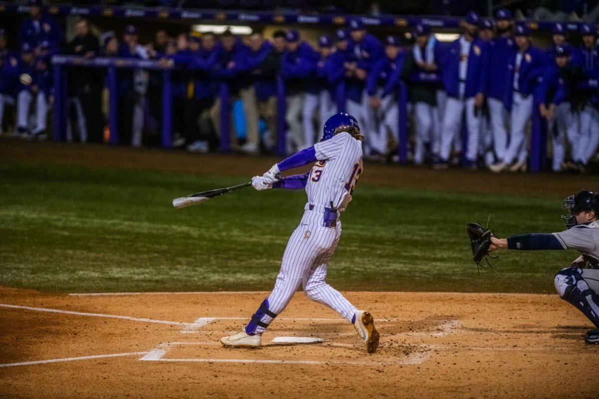 LSU baseball sophomore infielder Jordan Thompson (13) hits the ball Friday, Feb. 18, 2022 during LSU's 13-1 win against Maine at Alex Box Stadium on Gourrier Avenue in Baton Rouge, La.