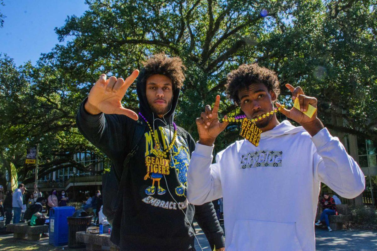 LSU men&#8217;s basketball freshman center Efton Reid III (15) poses with sophomore forward Tari Eason (13) Wednesday, Feb. 9, 2022 during the LSU Student Activities Board Mardi Gras Mambo event on Tower Drive at LSU's campus in Baton Rouge, La.