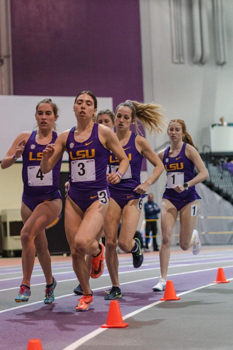 LSU track and field distance runners round the bend on Friday, Feb. 18, 2022, during the LSU Twilight track and field meet in the Carl Maddox Field House on Nicholson Drive in Baton Rouge, La.