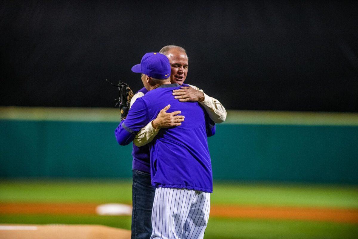 Former head coach Paul Mainieri and LSU head coach Jay Johnson hug after throwing the first pitch of the season Friday, Feb. 18, 2022 before LSU's 13-1 win against Maine at Alex Box Stadium on Gourrier Avenue in Baton Rouge, La.