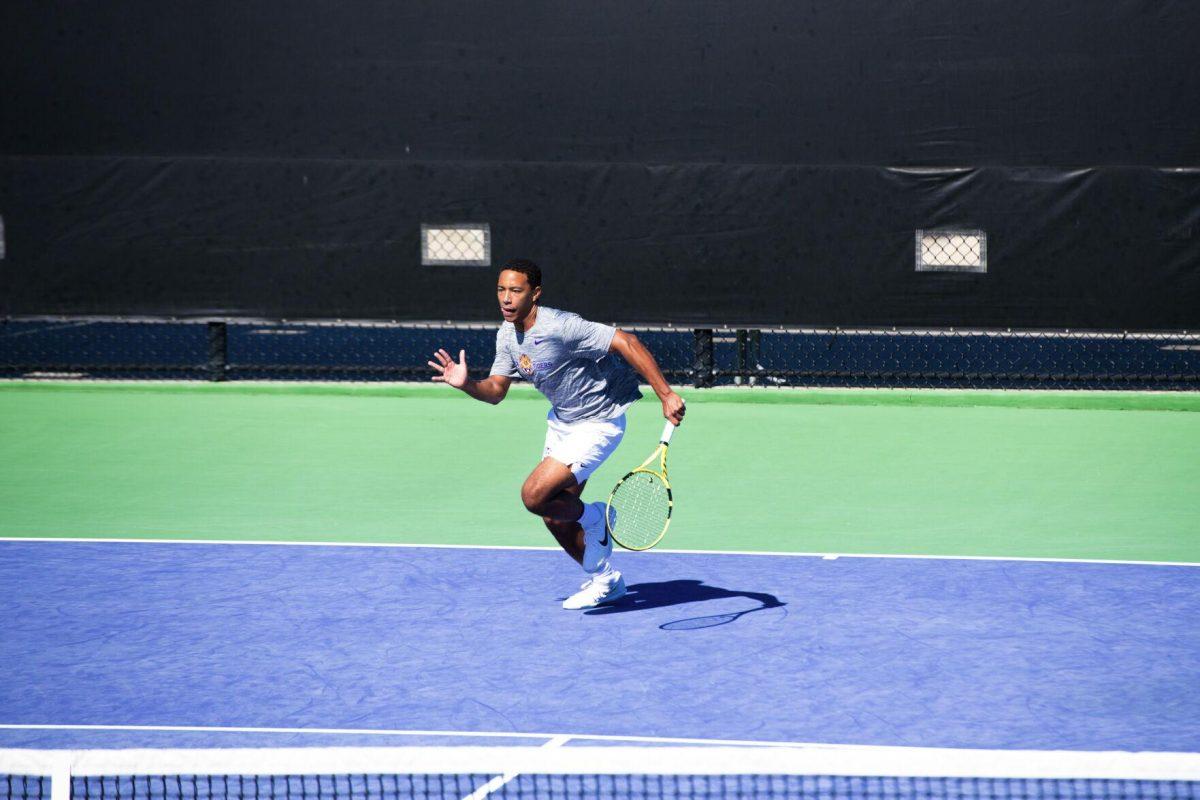 LSU men's tennis junior Kent Hunter sprints towards the tennis ball Sunday, Feb. 13, 2021 during LSU's 6-1 win over Purdue at the LSU Tennis Complex on Gourrier Avenue in Baton Rouge, La.