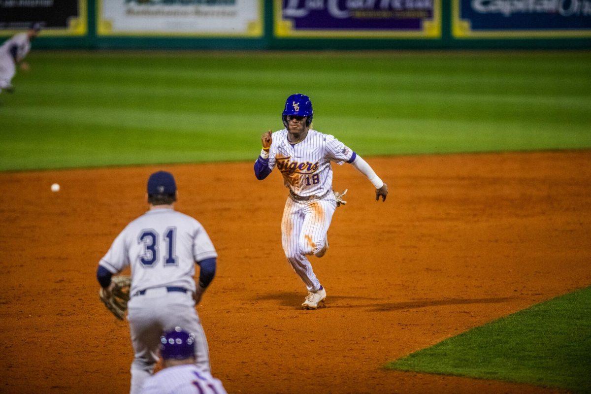 LSU baseball sophomore first baseman Tre Morgan III (18) steals third on an overthrow Friday, Feb. 18, 2022 before LSU's 13-1 win against Maine at Alex Box Stadium on Gourrier Avenue in Baton Rouge, La.