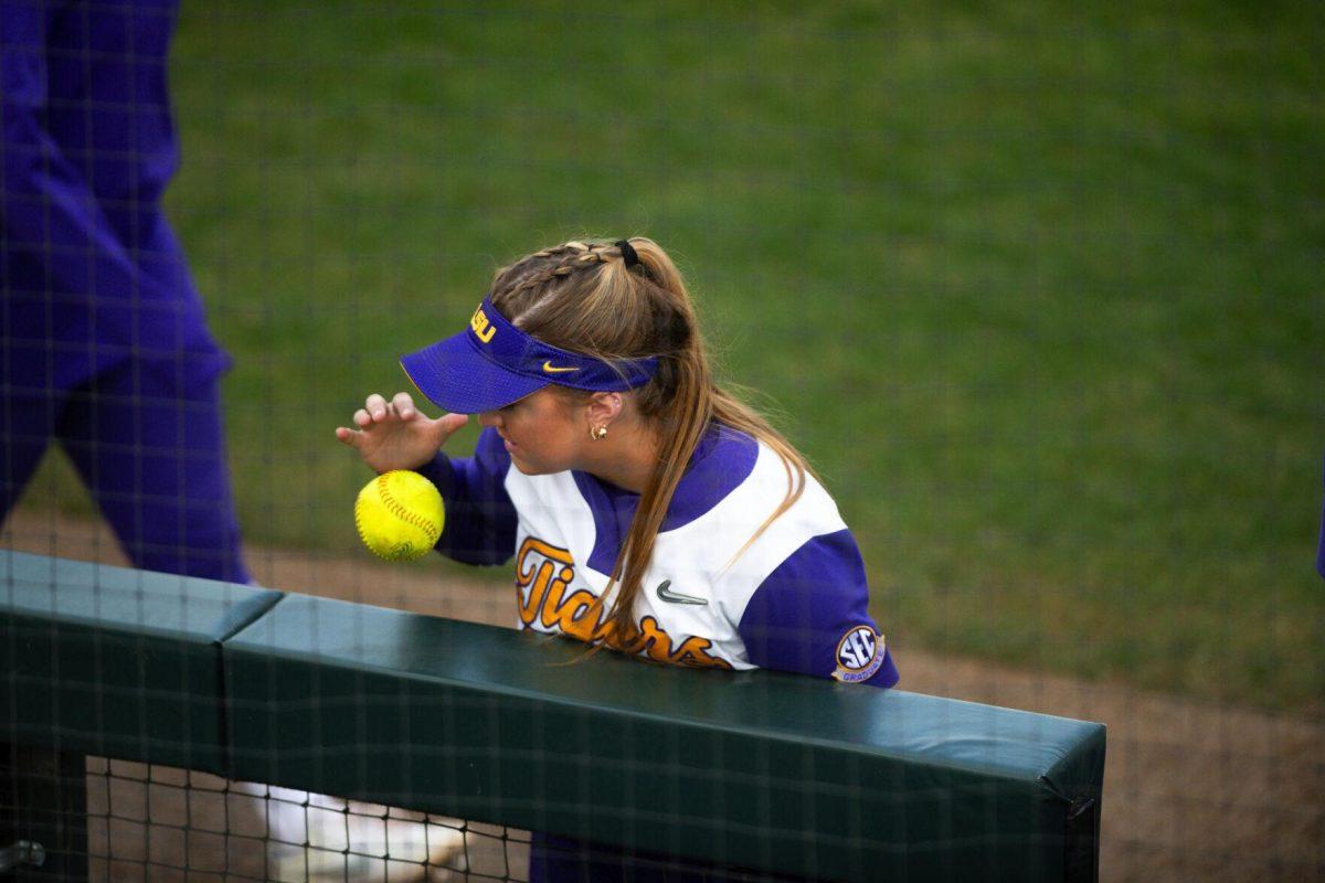 LSU softball junior outfielder Savannah Stewart (8) bounces a softball on the dugout railing Saturday, Feb. 12, 2022, during LSU’s 8-1 win against South Alabama at Tiger Park on Skip Bertman Drive in Baton Rouge, La.