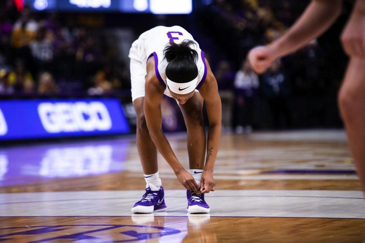 LSU women’s basketball graduate student guard Khayla Pointer (3) ties her shoe Sunday, Feb. 20, 2022, during LSU’s 66-61 win against Florida in the Pete Maravich Assembly Center on North Stadium Drive in Baton Rouge, La.