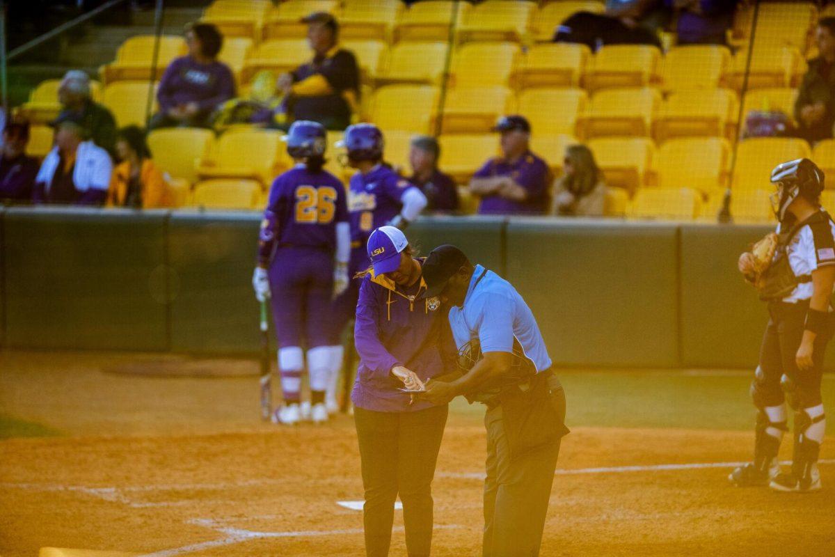 LSU softball head coach Beth Torina speaks to the umpire Friday, Feb. 11, 2022, during the Tigers' 3-0 win against South Alabama at Tiger Park in Baton Rouge, La.