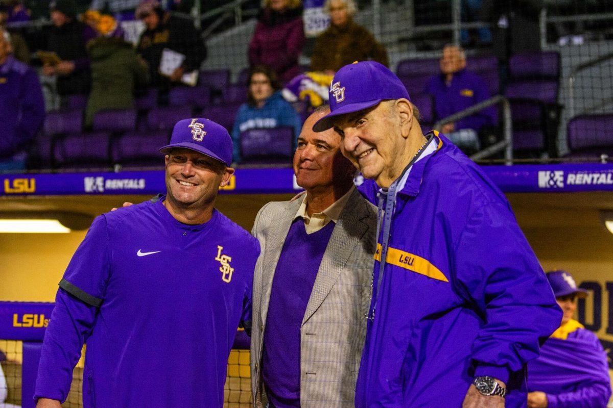 LSU head coach Jay Johnson, former head coach Paul Mainieri, and other former head coach Skip Bertman pose for a picture Friday, Feb. 18, 2022 before LSU's 13-1 win against Maine at Alex Box Stadium on Gourrier Avenue in Baton Rouge, La.