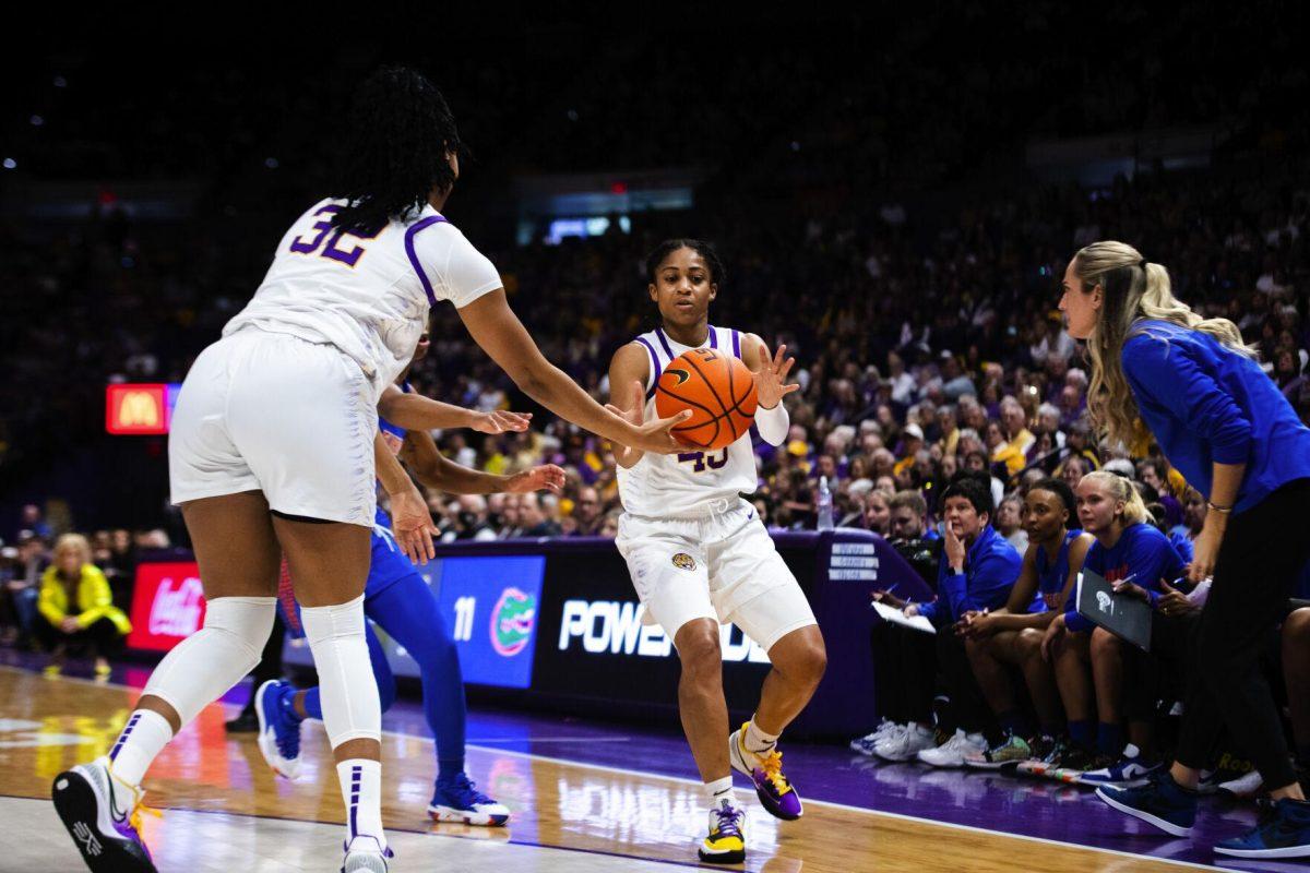LSU women’s basketball fifth year senior forward and guard Awa Trasi (32) hands the ball off to fifth year guard Alexis Morris (45) Sunday, Feb. 20, 2022, during LSU’s 66-61 win against Florida in the Pete Maravich Assembly Center on North Stadium Drive in Baton Rouge, La.