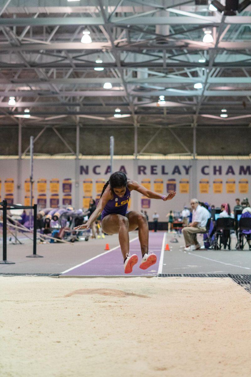 LSU track and field jumps fifth-year senior Kyndal McKnight reaches her legs out on Friday, Feb. 18, 2022, during the LSU Twilight track and field meet in the Carl Maddox Field House on Nicholson Drive in Baton Rouge, La.