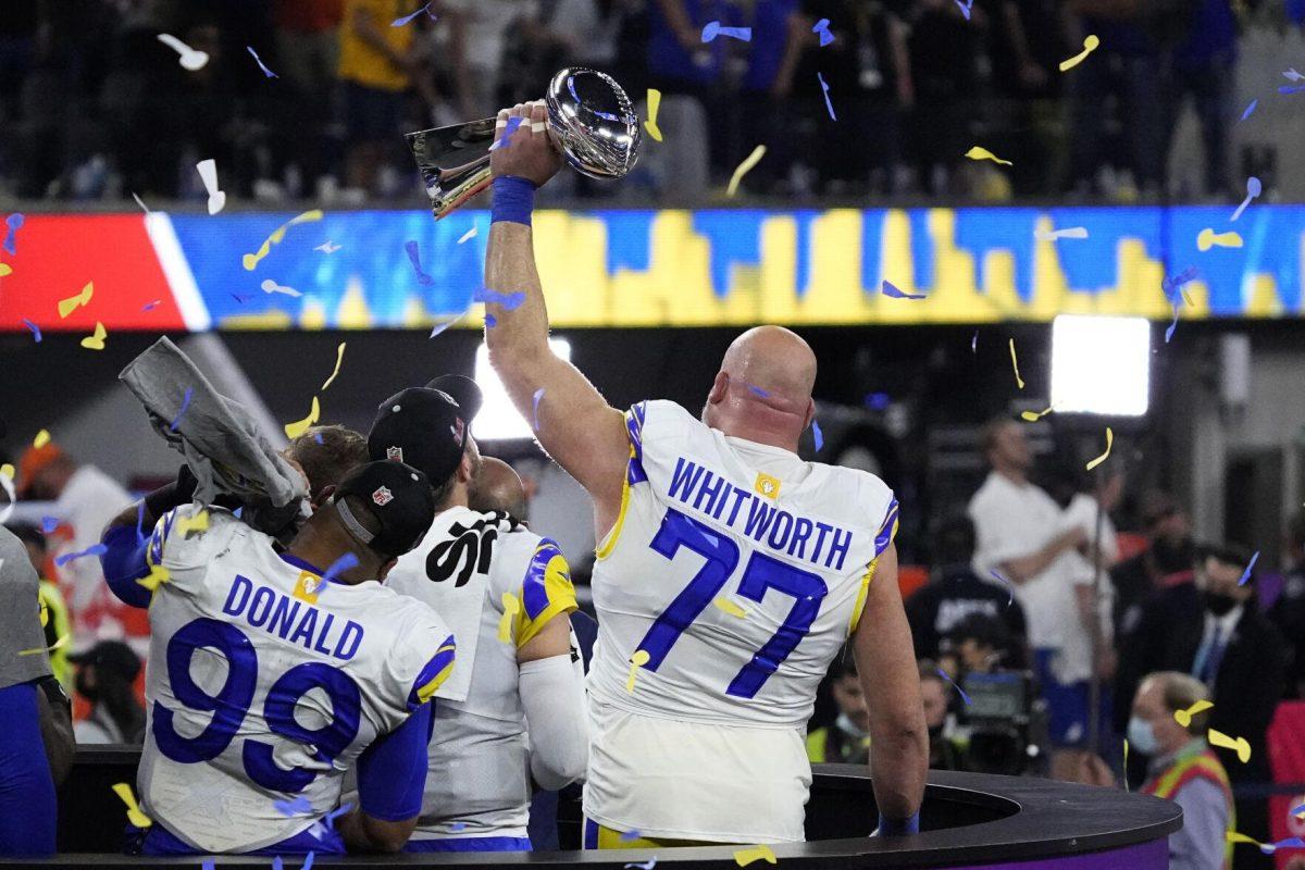 Los Angeles Rams offensive tackle Andrew Whitworth (77) holds the the Lombardi Trophy after the NFL Super Bowl 56 football game Sunday, Feb. 13, 2022, in Inglewood, Calif. The Los Angeles Rams won 23-20. (AP Photo/Julio Cortez)