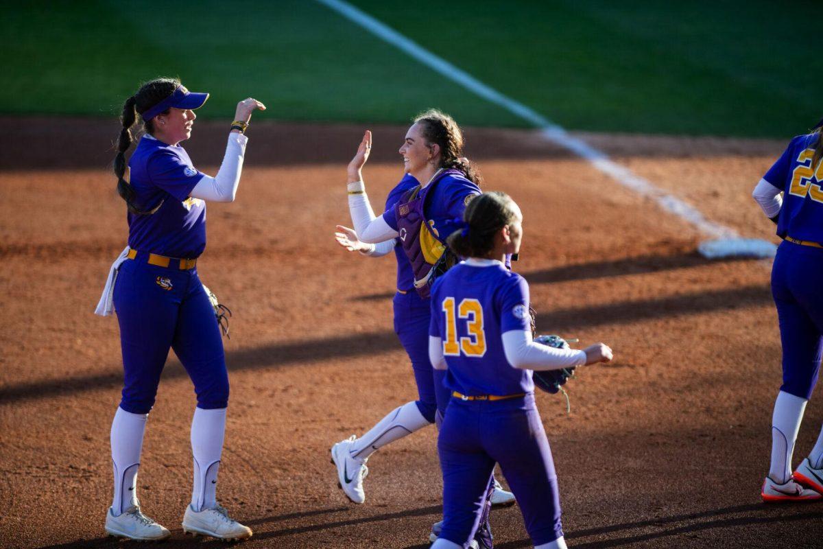 LSU softball redshirt sophomore infielder Taylor Pleasants (17) high fives redshirt junior catcher Morgan Cummins (26) Friday, Feb. 11, 2022, during the Tigers' 3-0 win against South Alabama at Tiger Park in Baton Rouge, La.