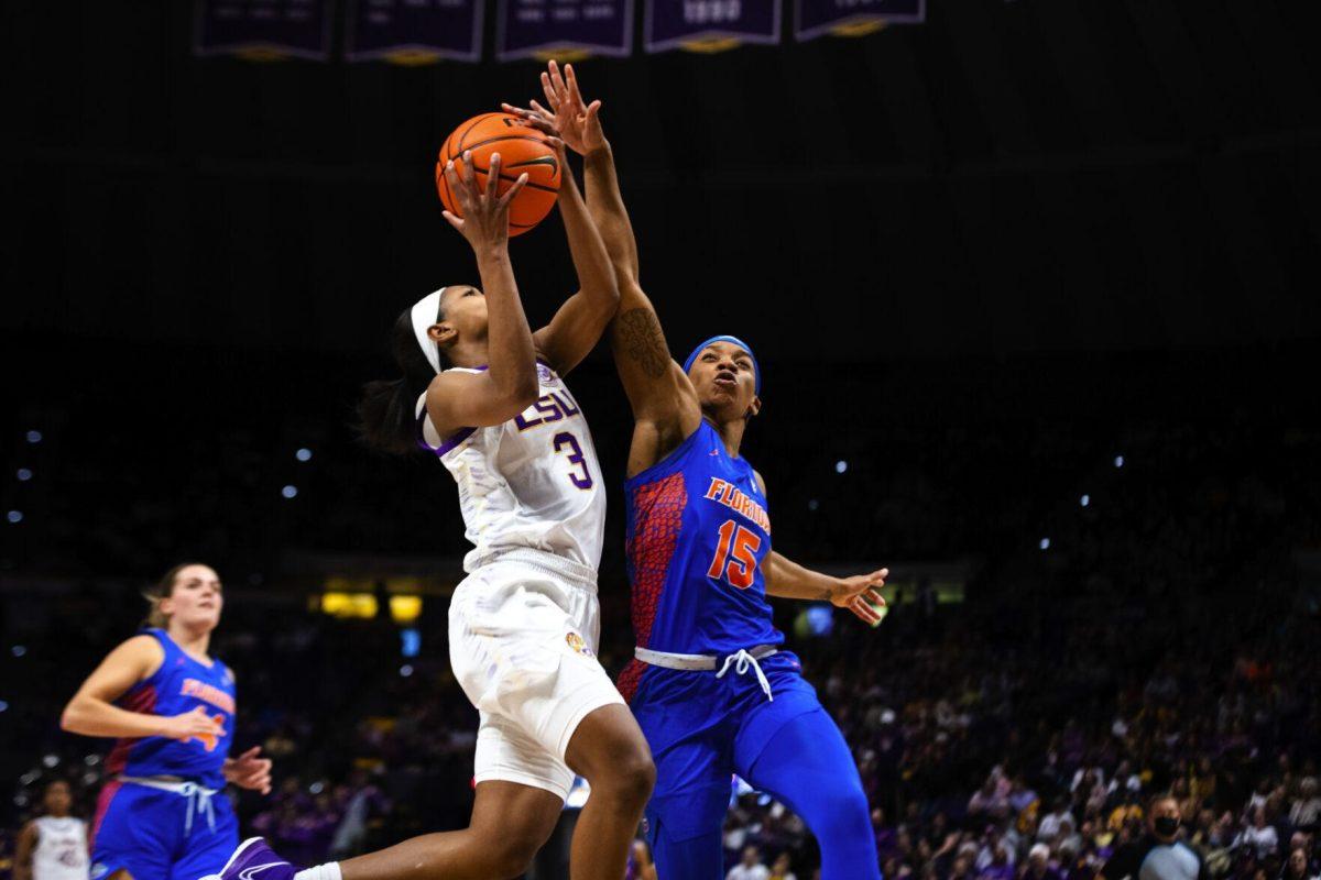 LSU women’s basketball graduate student guard Khayla Pointer (3) drives through the traffic for a shot attempt Sunday, Feb. 20, 2022, during LSU’s 66-61 win against Florida in the Pete Maravich Assembly Center on North Stadium Drive in Baton Rouge, La.