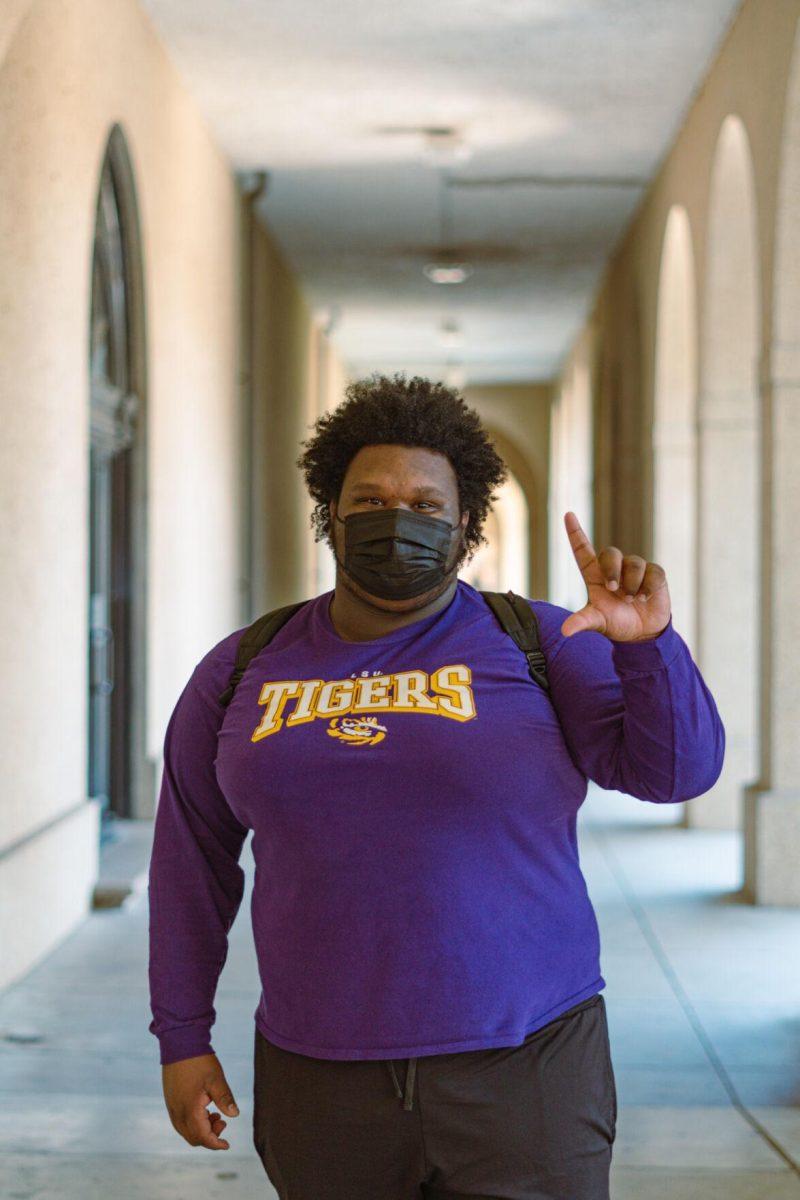 LSU political science freshman Justin Butler shows off his purple and gold Tigers t-shirt on Tuesday, Feb. 15, 2022, outside of Dodson Hall in Baton Rouge, La.