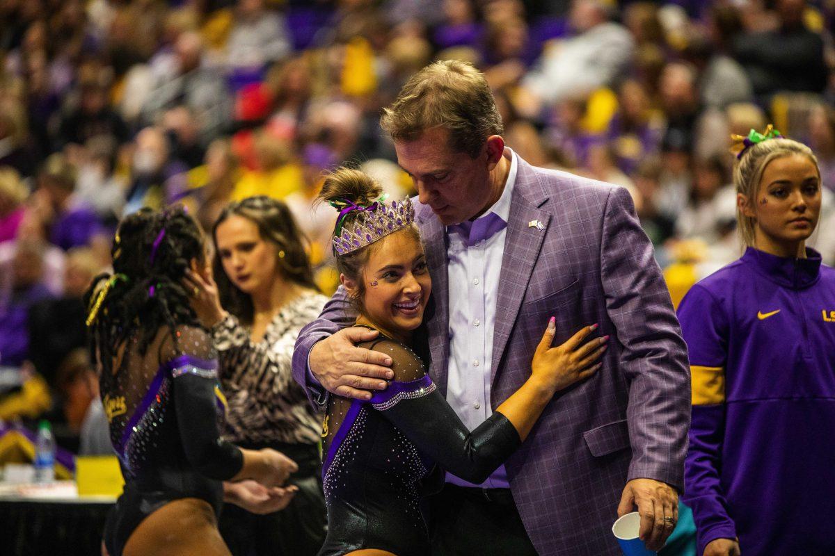 LSU gymnastics graduate student balance beam and floor exercise Christina Desiderio hugs head coach Jay Clark after her balance beam routine Friday, Feb. 18, 2022 during LSU's 198.050-197.650 win over the University of Alabama in the Pete Maravich Assembly Center on N. Stadium Drive in Baton Rouge, La