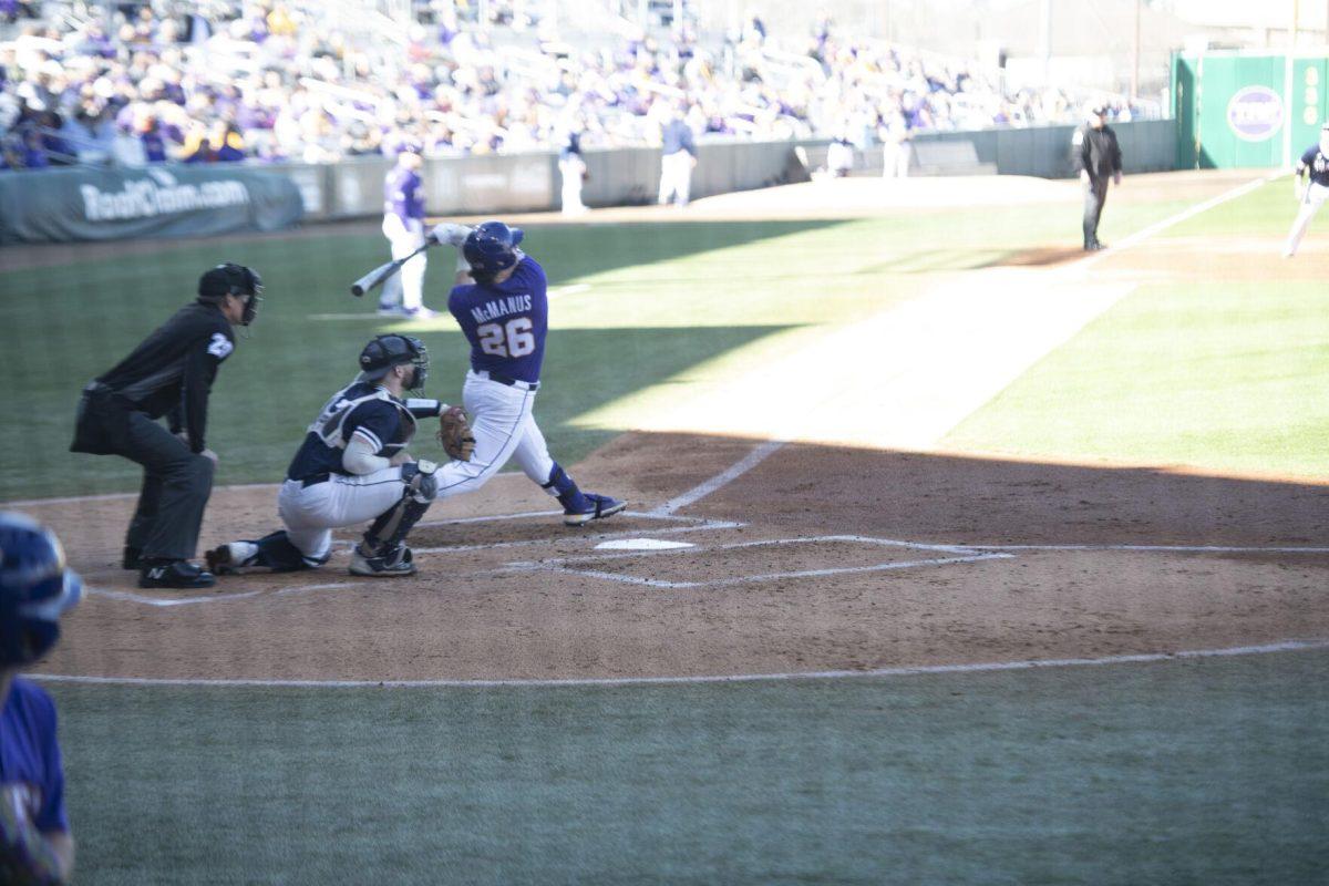 LSU graduate student Tyler McManus (26) swings the bat Saturday, Feb. 19, 2022, during the Tigers' 17-8 win against the University of Maine at Alex Box Stadium in Baton Rouge, La.