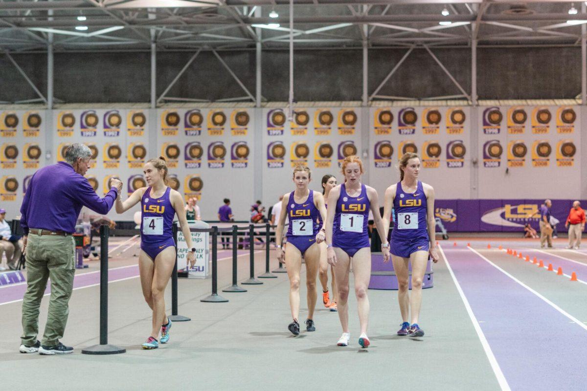 LSU track and field distance runners walk along the inside of the track on Friday, Feb. 18, 2022, after their race during the LSU Twilight track and field meet in the Carl Maddox Field House on Nicholson Drive in Baton Rouge, La.