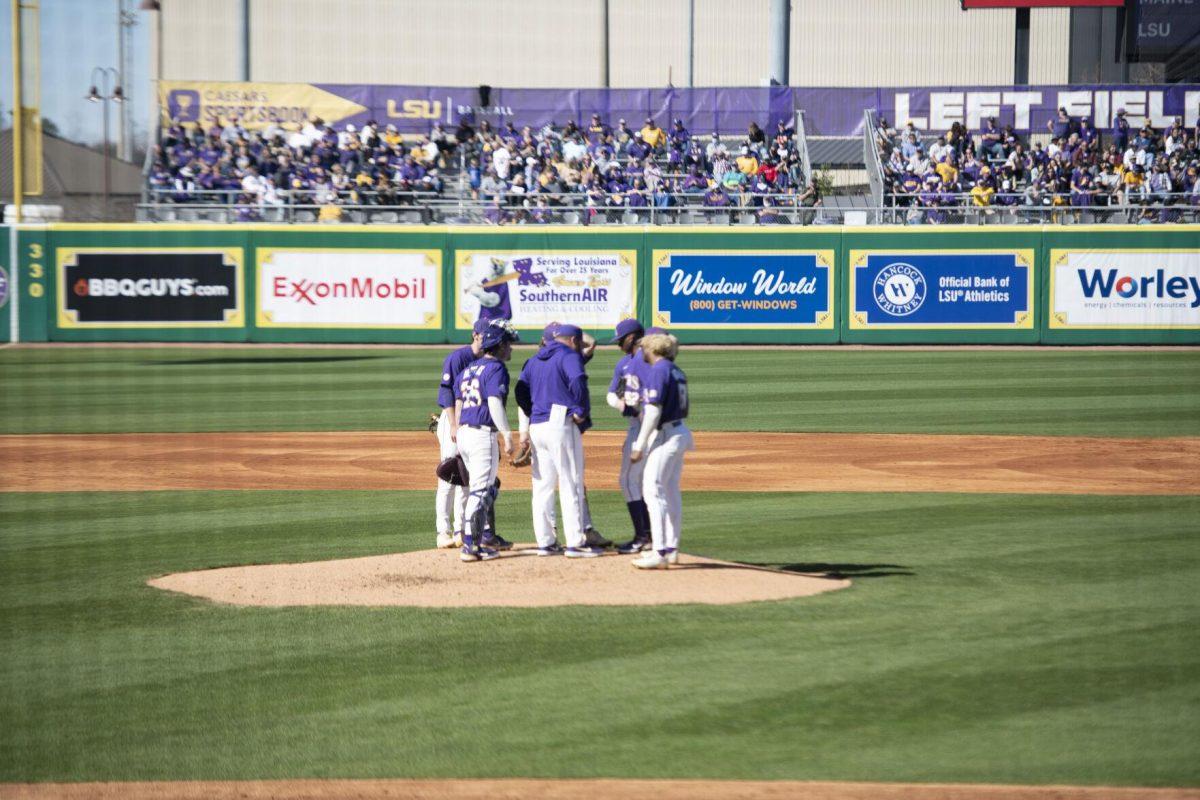 LSU pitching coach Jason Kelly meets with the infielders, outfielders, catchers, and pitcher on the mound Saturday, Feb. 19, 2022, during the Tigers' 17-8 win against the University of Maine at Alex Box Stadium in Baton Rouge, La.