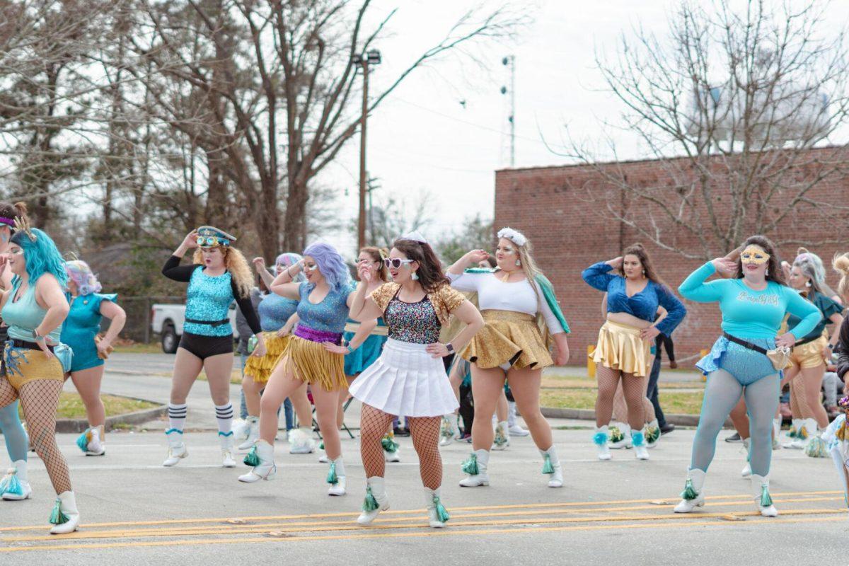 A group of dancers perform on Sunday, Feb. 20, 2022, as part of the Mid City Gras parade on North Boulevard in Baton Rouge, La.